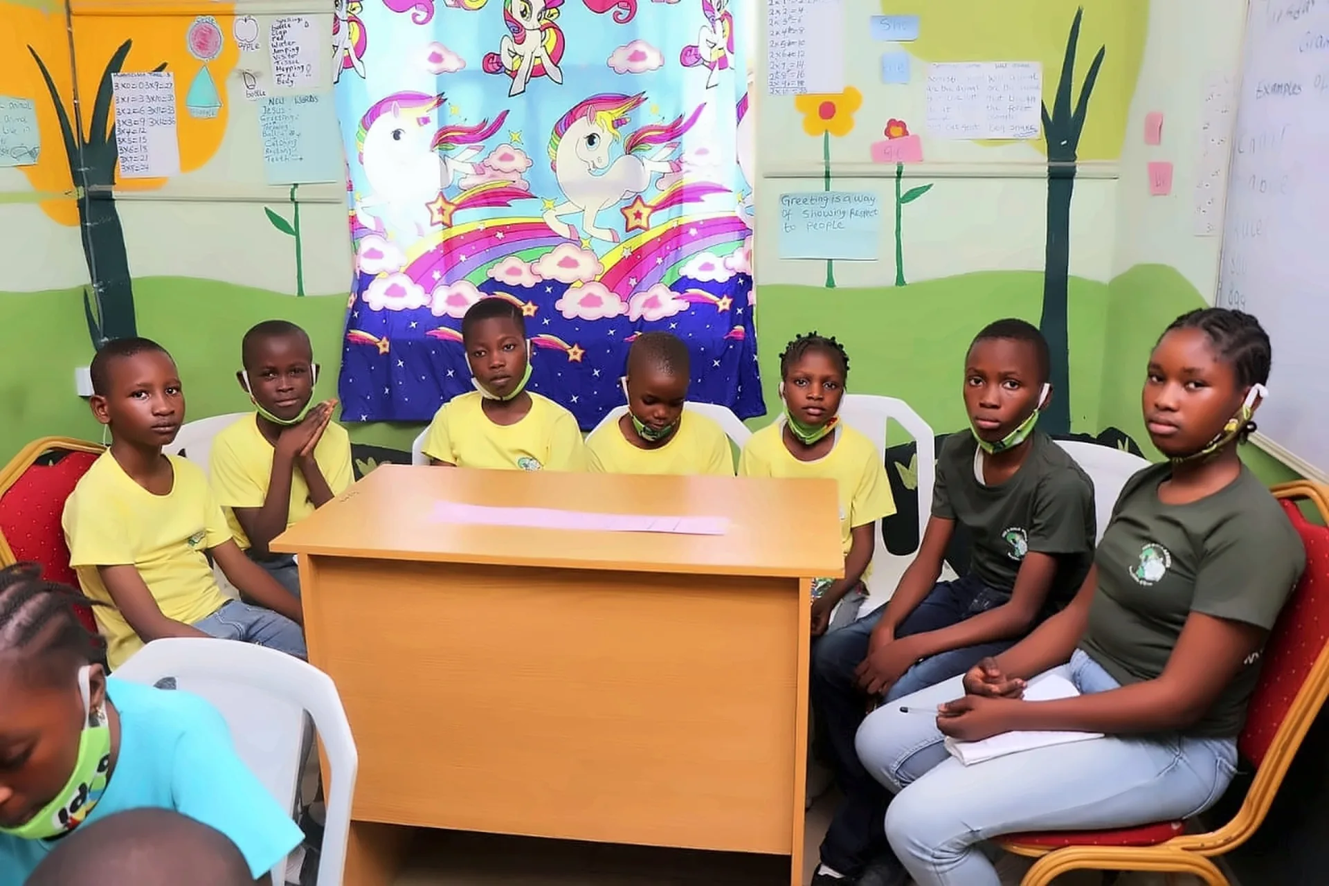 Fruitful Trees pupils seated around a desk during a group learning session.